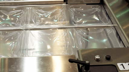 Vacuum food package conveyor machine. Vacuum packaging helps to keep food fresh a long time.