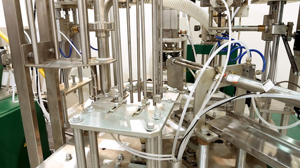 Tanks and containers connected with tubes pipes and valves. Laboratory at food brewing production factory plant. Chemical research tests are important in any production process.
