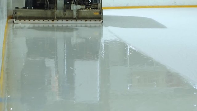 Machine cleans ice skating rink