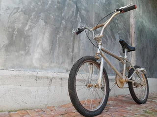 Foto op Canvas Een fiets, vintage fietsstijl, betonnen muur, BMX-fiets. © Pittaya