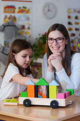 Portrait of Preschool Teacher With Cute Girl