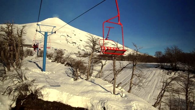 View from the ski lift, skiers and snowboards using the ski lift to go to the top of the resort. Ski Pucon is a ski field situated close to the Volcan Villarrica.