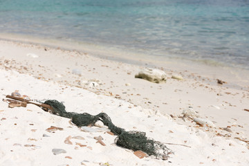 wild beach and the old network in the sand