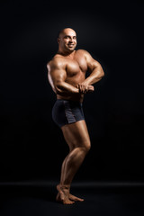 Obraz premium Bodybuilder Topless Over Black Background