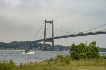 Sailboat Passing a Bridge