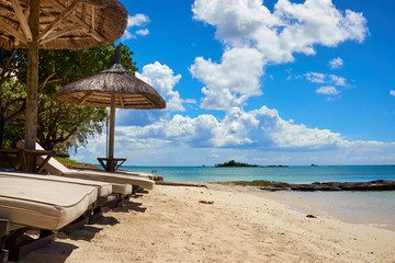 White sand beach with lounge chairs and umbrellas in Mauritius I