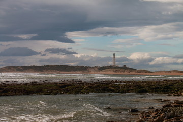 The lighthouse of Cape Trafalgar on a cloudy day, on the coasts of southern Spain