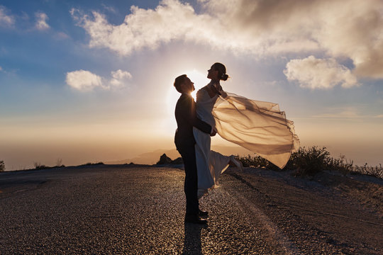 Wedding couple on the road, sunset light