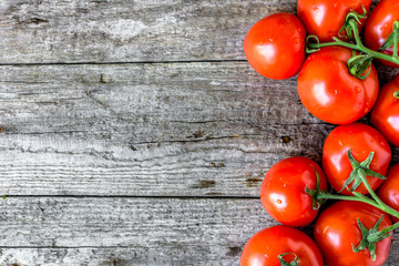 Top view of tomatoes, organic vegetables, fresh produce on wooden background