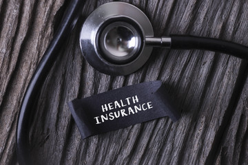Medical Concept- HEALTH INSURANCE word written on label tag