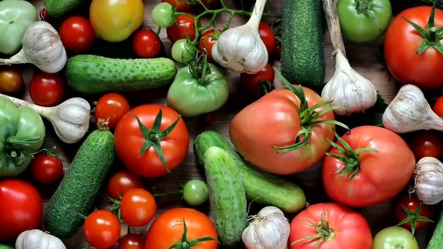 cucumbers, tomatoes and garlic on the table, top view. footage from the photo, slow motion.