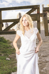 Fototapeta na wymiar Young bride, beautiful blonde, at horse ranch