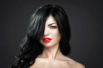 Fototapeta premium Beautiful brunette woman with shot hairstyle and sexy red lips.