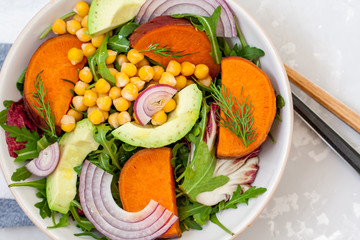 Warm salad with sweet potato and chickpeas. Love for a healthy food concept