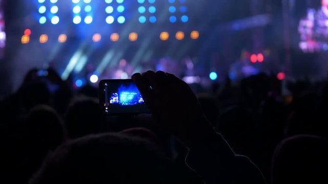 4K making video with cell phone at live music concert, festival