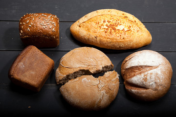 Homemade bread on a black wooden background