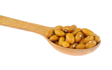 Brown yellow beans in wooden spoon