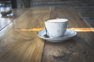 Close up white cup of Coffee, latte on the wooden table
