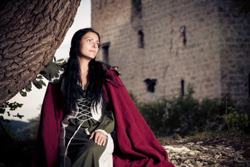 Naklejka premium Lady Posing In Front Of A Fortress Ruin