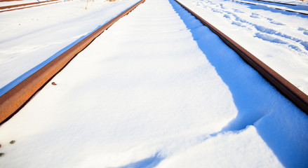 Covered with snow railroad tracks