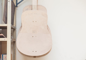 a row of classical unfinished guitar at workshop