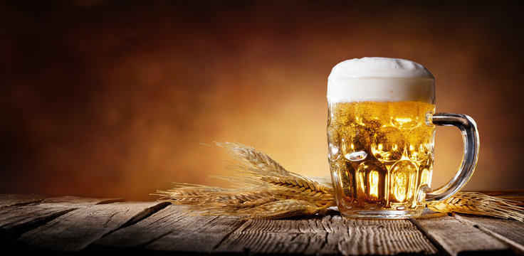 Beer With Wheat On Wooden Table
