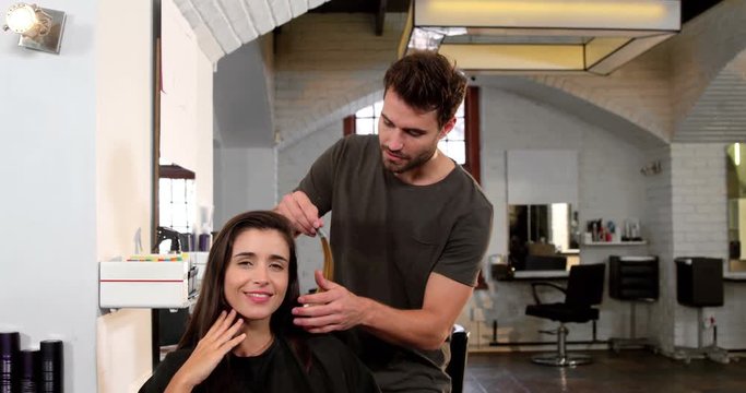 Male hairstylist styling customers hair