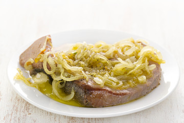 fried tuna with onion on white plate