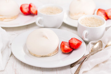 meringue with strawberries on plate