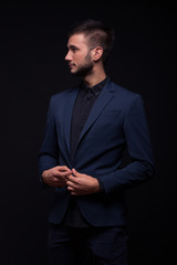 man posing studio elegant suit, looking sideways