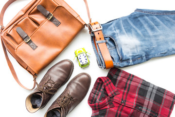 Men's casual outfits with leather bag, red plaid shirt, blue jeans, man clothing and accessories travel items on white background