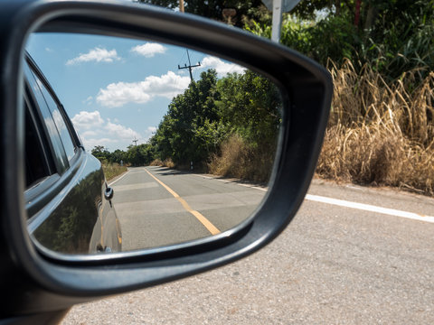 Car side mirror reflex the road.