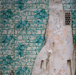 old wall with torn wallpaper