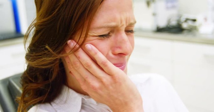Unhappy female patient having a toothache