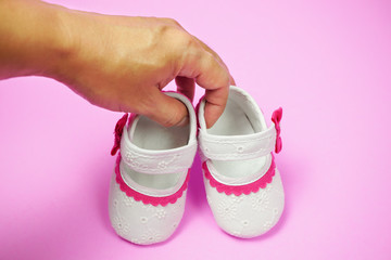 Children's shoes pink background.