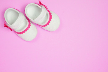 Fototapeta na wymiar Children's shoes pink background.