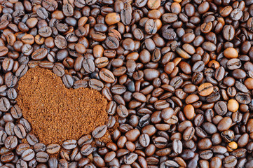 Grains of roasted coffee. Coffee in a heart shape for the background