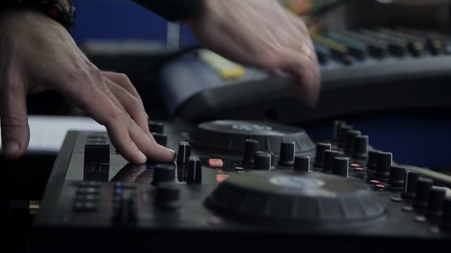 Hands DJ behind the decks