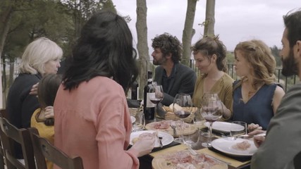 Family dining outdoors - Powered by Adobe