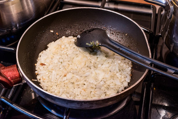 Onion frying in pan