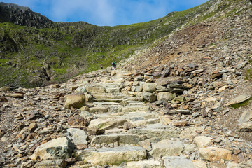 Fototapeta na wymiar Stone path in Snowdonia National Park, North Wales, United Kingdom; view of the mountains 