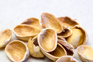 Empty pistachio nut shells on each other