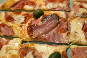 Homemade sliced pizza with bacon