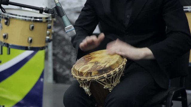 Musician on stage playing the African drum. Close-up