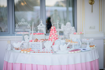Beautiful candy bar of pink and white sweets decorated with figu