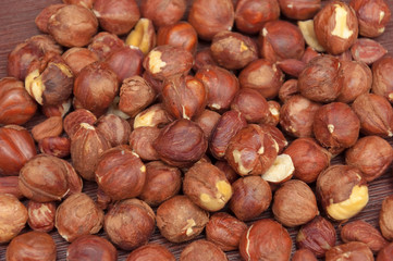 Hazelnuts at wooden background.