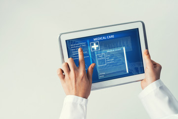 Close of female doctor hands working with tablet pc computer
