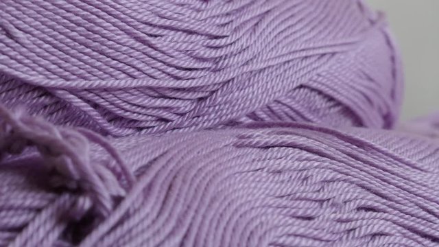 Tilting over yarn of wool lot wrapped in loose twist 4K 2160p 30fps UltraHD footage - Slow tilt on skeins of purple knitting wool shallow DOF 3840X2160 UHD video