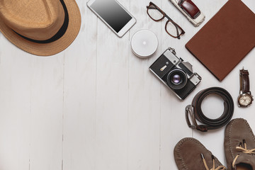 Set of men's accessories for the tourist on a white wooden background. The fashion, leisure and travel concept