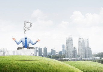 Headless meditating businessman